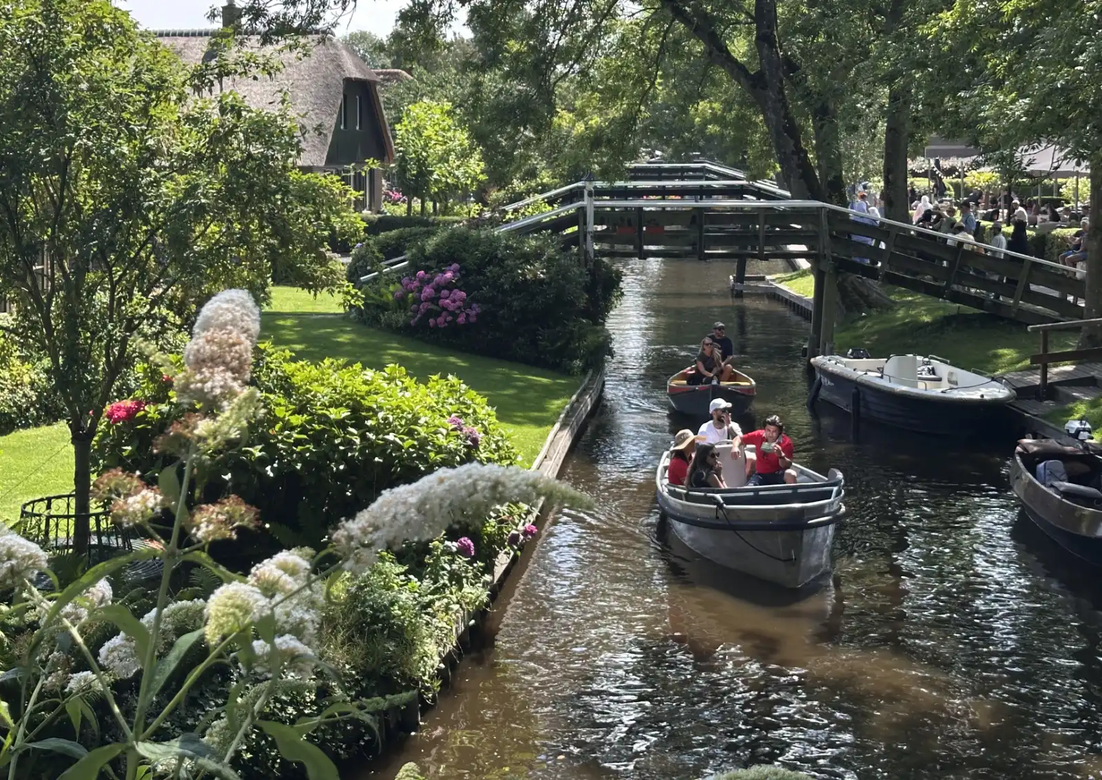 Some of Giethoorn's 176 wooden bridges over a peaceful canal