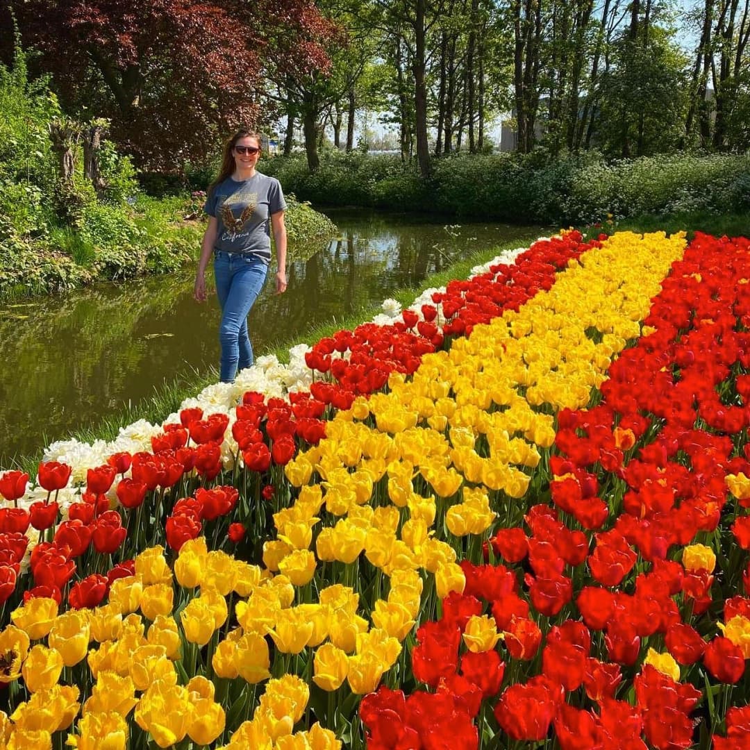 Women walking past tulips